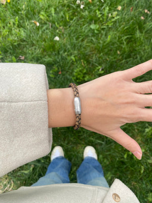 Vertig Magnetic Leather Bracelet Vintage White (Slim) on a woman's wrist. Adds a sophisticated touch, highlighting its slender profile and genuine vintage white leather.